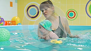 Baby Swimming with Coach in the Paddling Pool