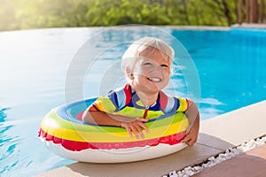 Baby in swimming pool. Kids swim. Child summer fun.