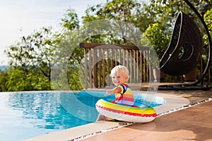 Baby in swimming pool. Kids swim. Child summer fun.