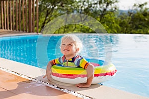 Baby in swimming pool. Kids swim. Child summer fun.