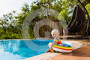 Baby in swimming pool. Kids swim. Child summer fun.