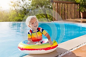 Baby in swimming pool. Kids swim. Child summer fun.