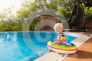 Baby in swimming pool. Kids swim. Child summer fun.