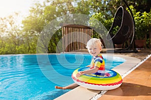 Baby in swimming pool. Kids swim. Child summer fun.