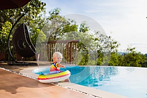 Baby in swimming pool. Kids swim. Child summer fun.