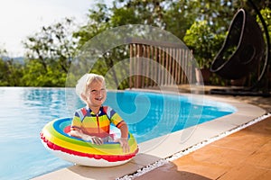 Baby in swimming pool. Kids swim. Child summer fun.