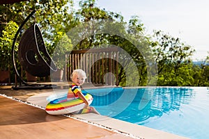 Baby in swimming pool. Kids swim. Child summer fun.