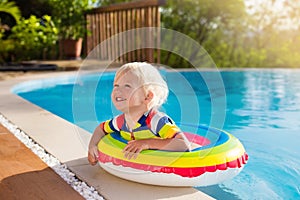 Baby in swimming pool. Kids swim. Child summer fun.