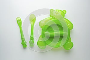 Baby tableware plastic dish plate onbright background, top view