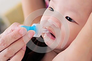 Baby taking medicine with dropper