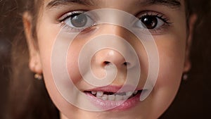 Baby teeth. Toothless smile. Cutting root tooth. The girl opens her lips and shows no front teeth. Close up