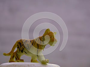Baby tiger toy animal isolate at natural white wall background