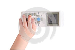 Baby toddler boy holds the air conditioner remote control in his hand, is