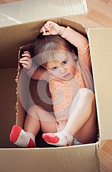 Baby toddler in a carton box