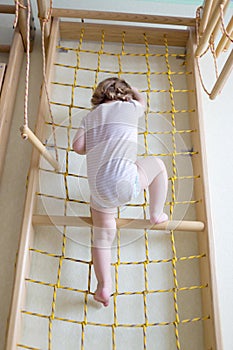 Baby toddler climbing up stairs.