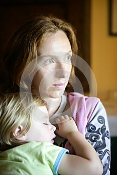 Baby toddler girl sleeping in mother arms