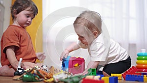 baby toddler group playing with toys animal. happy family a kid dream concept. baby toddler playing on the floor indoors