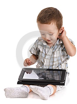 Baby toddler looking bemused at a digital tablet