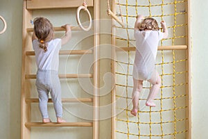 Baby toddlers climbing up the stairs.