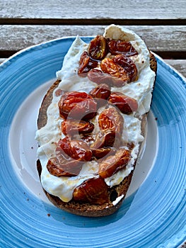 Baby Tomatoes on Bruschetta Toast with Burrata Cheese and Roasted Garlic