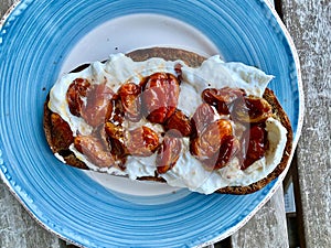 Baby Tomatoes on Bruschetta Toast with Burrata Cheese and Roasted Garlic