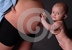 Baby touching pregnant abdomen