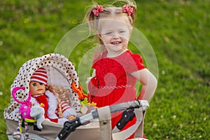 baby with toy stroller and doll