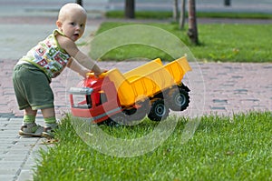 Baby with toy truck