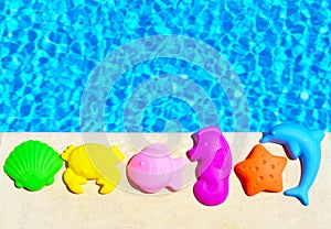 Baby Toys on the pool background.