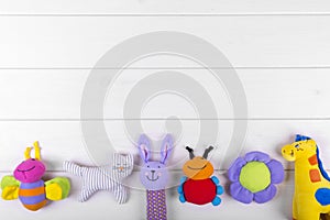 Baby toys on wooden background with copy space