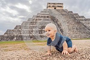 Baby traveler, tourists observing the old pyramid and temple of the castle of the Mayan architecture known as Chichen