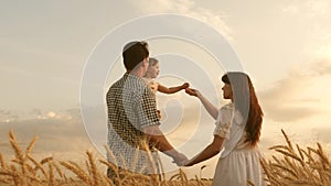 Baby travels across field with her family. child and parent are playing. happy family and childhood concept. Happy baby