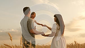 Baby travels across field with her family. child and parent are playing. happy family and childhood concept. Happy baby