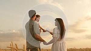 Baby travels across field with her family. child and parent are playing. happy family and childhood concept. Happy baby
