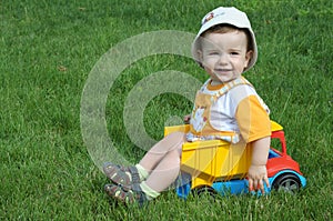 A baby in the truck on the grass