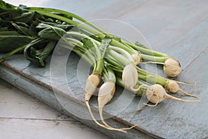 Baby turnips on wooden board