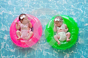 Baby Twin Girls Floating on Swim Rings