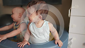 baby twins play in a dry ball pool. happy family kid dream concept. baby smiling play in dry pool at home indoors two