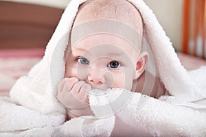 Baby under white towel