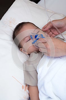 Baby using spacer for respiratory infection photo