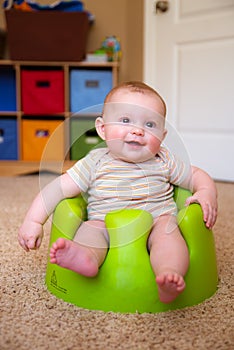 Baby using training Bumbo seat to sit up