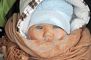 Baby in warm clothes in cold weather