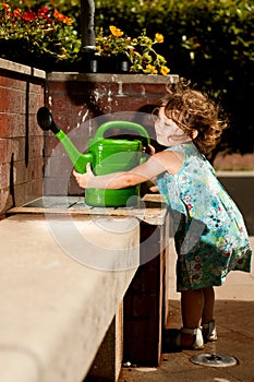 Baby with watering pot