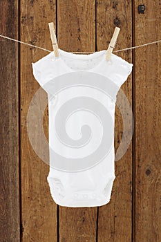 Baby wear hanging in clothespins on washing line
