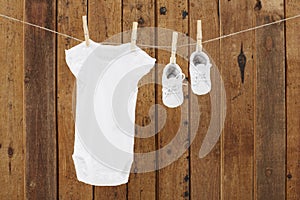 Baby wear hanging in clothespins on washing line photo