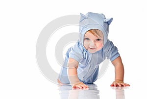 Baby wearing funny suit crawling on studio floor