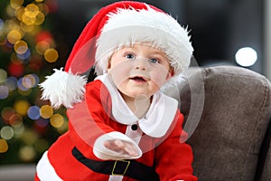 Baby wearing santa costume at home