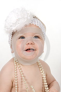 Baby Wearing White Pearls and Large Floral Headband