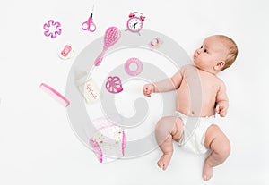 Baby on white background with clothing, toiletries, toys and health care accessories for girls. Wish list or shopping