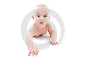 Baby on a white background smiling and looking at the came